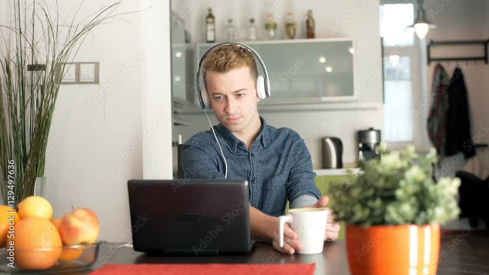 Man laughing while watching something on laptop
Man laughing while watching something on laptop