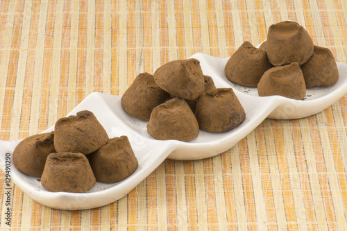 trufas de chocolate en tres recipientes blancos photo