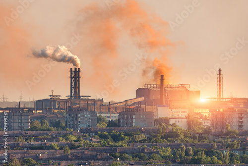 Metallurgy plant at sunset. Steel mill. Heavy industry factory. Steel factory with smog. Pipes with smoke. Metallurgical plant in city. steel, iron works. Ecology problems, atmospheric pollutants