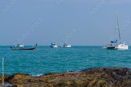 Beautiful landscape seaview with catamaran and boat at beach of Laem Panwa Cape famous attractions in Phuket island, Thailand photo