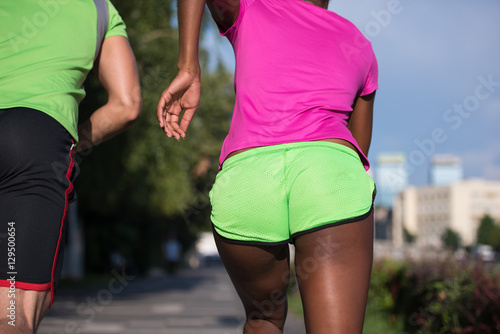 young smiling multiethnic couple jogging in the city © .shock