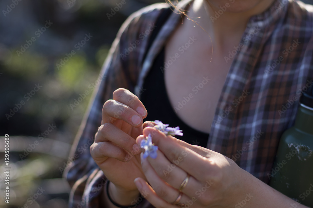 woman picking small flowers