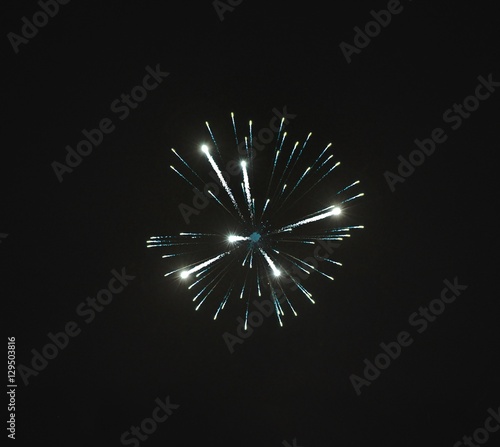 Shiny natural fireworks on dark sky background with little smoke