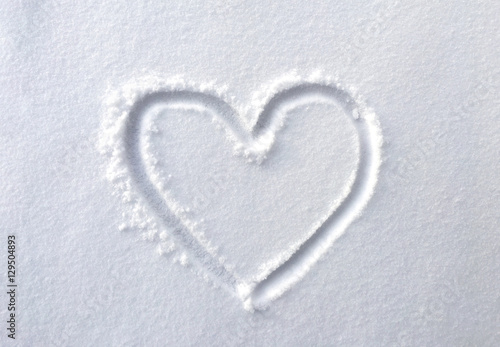 hand drawn heart shape in the fresh snow