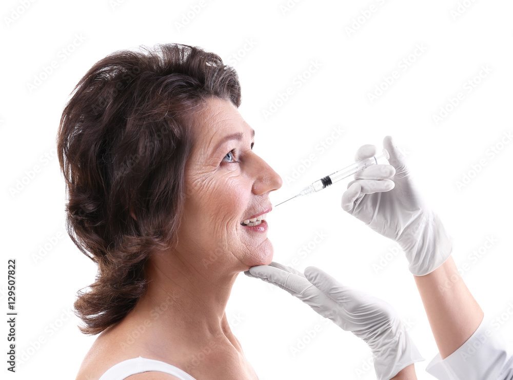Senior woman having hyaluronic acid injection at beauty salon Senior woman having hyaluronic acid injection at beauty salon