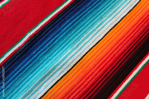 poncho Mexican cinco de mayo rug blanket serape fiesta traditional Mexico poncho background Mexican stripes copy space blanket minimal simple cinco de mayo serape pattern background  -  stock photo