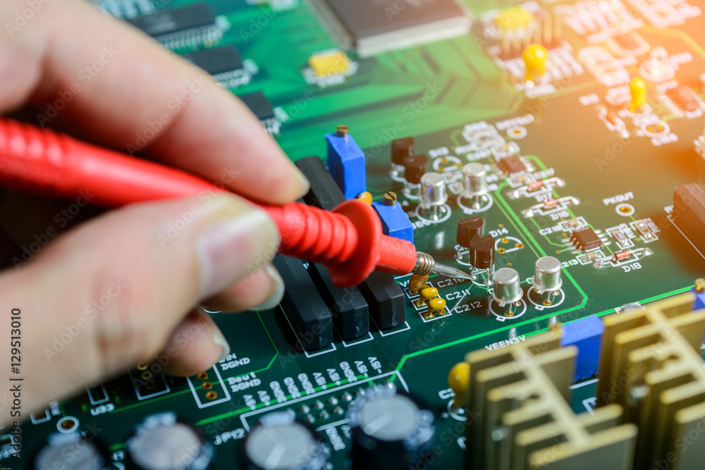 Fototapeta premium Male hands close up checking voltage on transistor