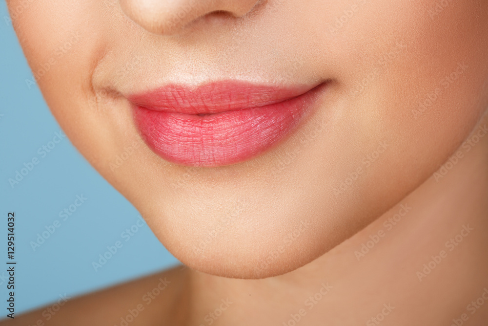 Obraz premium Perfect natural lip makeup. Close up macro photo with beautiful female mouth. Plump full lips. Close-up face detail. Perfect clean skin, light fresh lip make-up. Beautiful spa tender lip