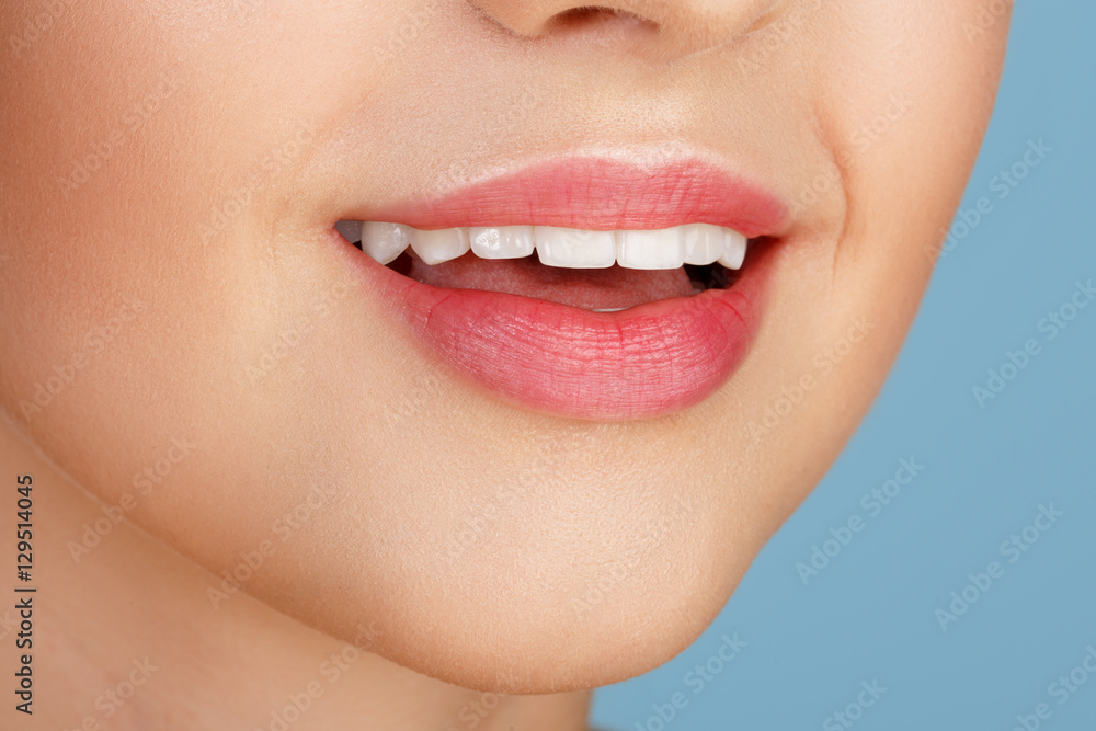 Obraz premium Perfect natural lip makeup. Close up macro photo with beautiful female mouth. Plump full lips. Close-up face detail. Perfect clean skin, light fresh lip make-up. Beautiful spa tender lip