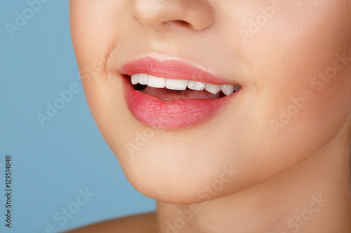 Perfect natural lip makeup. Close up macro photo with beautiful female mouth. Plump full lips. Close-up face detail. Perfect clean skin, light fresh lip make-up. Beautiful spa tender lip