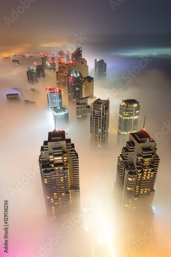 Photography Rare early morning winter fog above the Dubai Marina skyline and skyscrapers ahead of sunrise in Dubai, United Arab Emirates