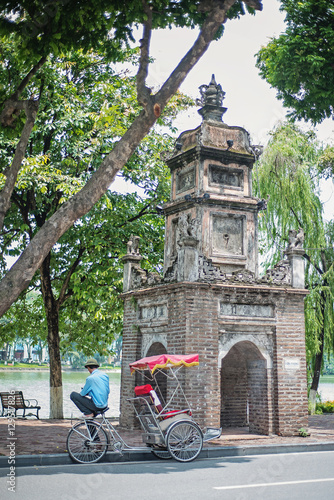 A bicycle cyclo driver waits for his next customer near the Hoan Kiem Lake in Hanoi, Vietnam.