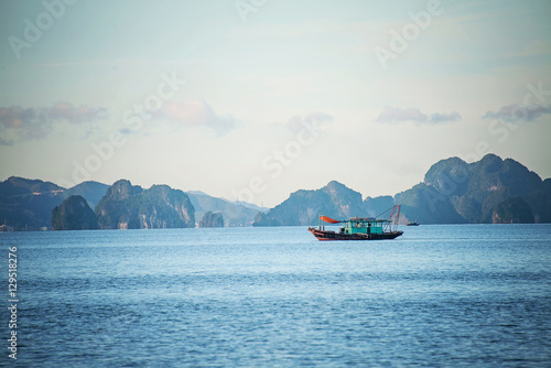 A fishing boat in Ha Long Bay at dusk