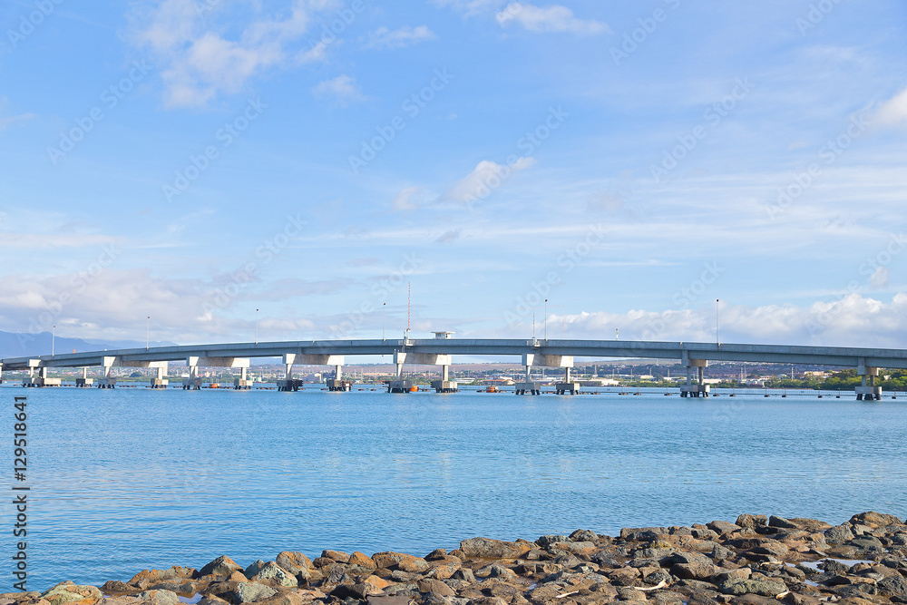 Admiralty Clarey Bridge, Ford Island, Pearl Harbor, Hawaii. Bridge view from the shore stones on a sunny day.