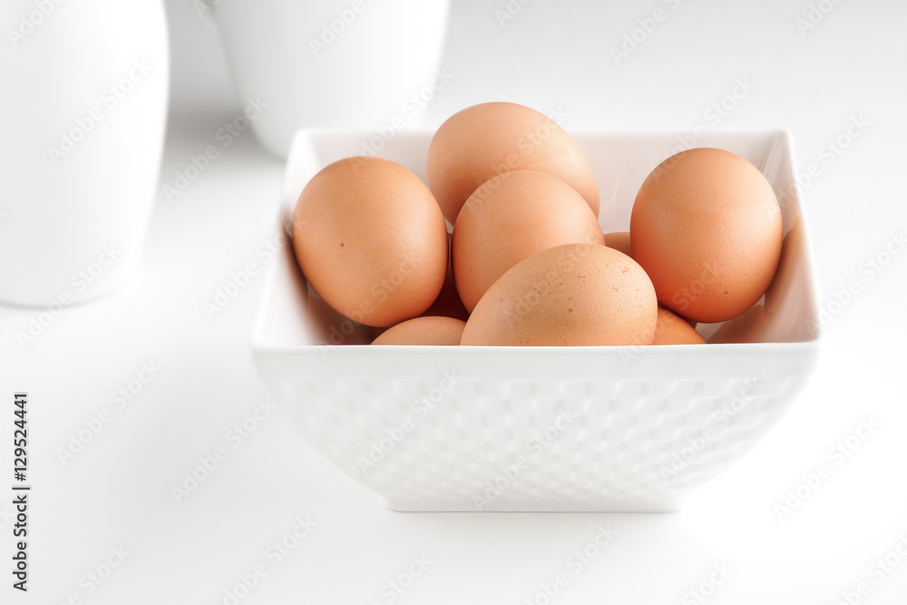 Eggs in bowl still life high key on white Eggs in bowl still life high key on white
