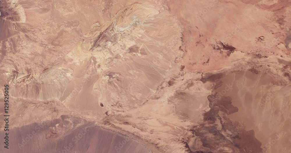 High-altitude overflight aerial of Iran's Dasht-e Kavir (Great Salt Desert). Clip loops and is reversible. Elements of this image furnished by USGS/NASA Landsat High-altitude overflight aerial of Iran's Dasht-e Kavir (Great Salt Desert). Clip loops and is reversible. Elements of this image furnished by USGS/NASA Landsat