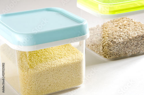 Food storage. Food ingredients (cous cous and wild rice) in plastic containers. Selective focus.