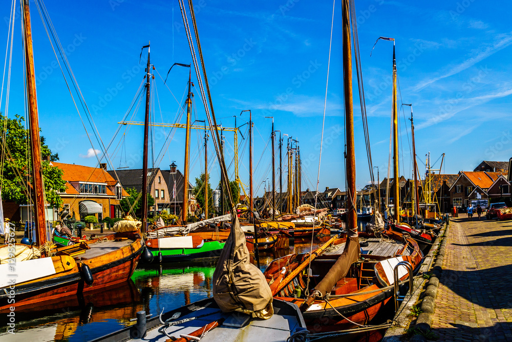 Traditional Dutch Botter Fishing Boats in the Harbor of the historic village of Spakenburg-Bunschoten. The village was once a major fishing center on the now dammed IJselmeer Traditional Dutch Botter Fishing Boats in the Harbor of the historic village of Spakenburg-Bunschoten. The village was once a major fishing center on the now dammed IJselmeer