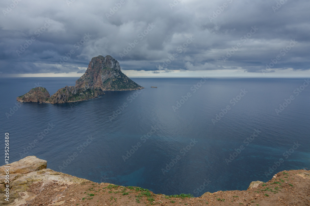 Fototapeta premium Clouds over the mysterious island of Es Vedra