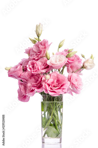 bunch of pink eustoma flowers in glass vase