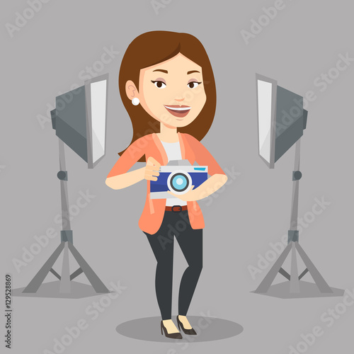 Photographer with camera in photo studio.