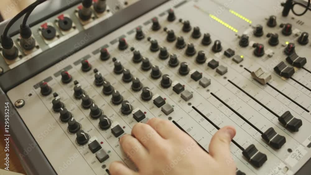 Hands on radio audio mixer sound console.
