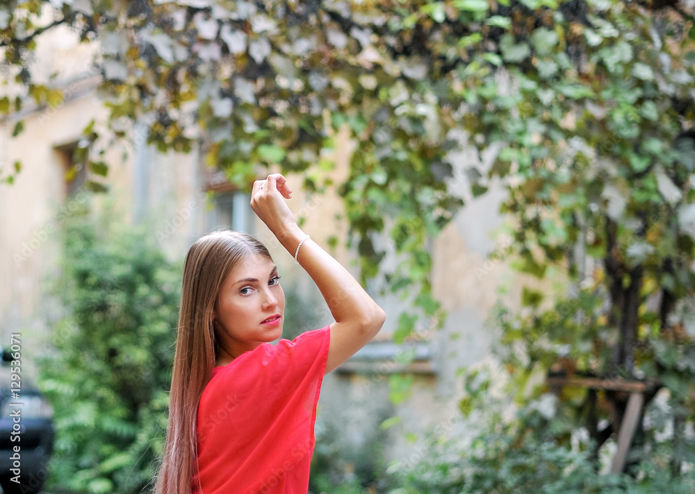 Fototapeta premium Portrait of beautiful female model in the garden 