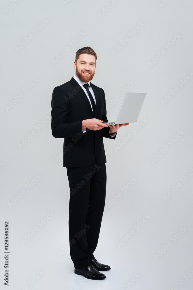 Full length business man holding laptop Full length business man holding laptop