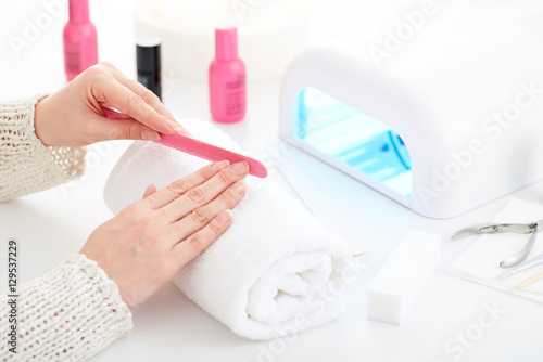 Manicure and hybrid nails painting process.