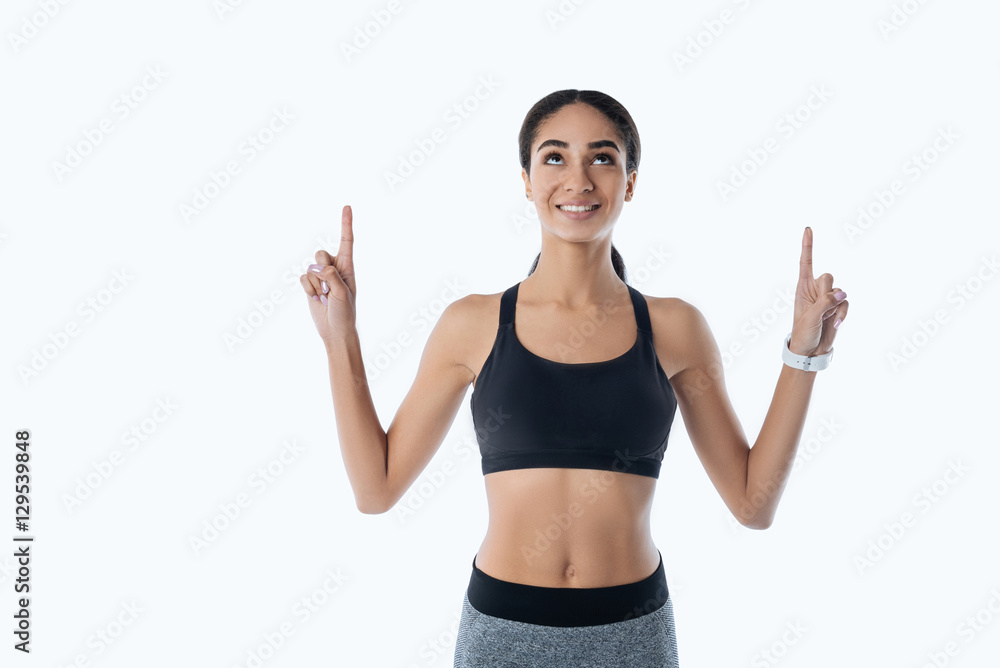Pleasant young sportswoman looking upwards Pleasant young sportswoman looking upwards