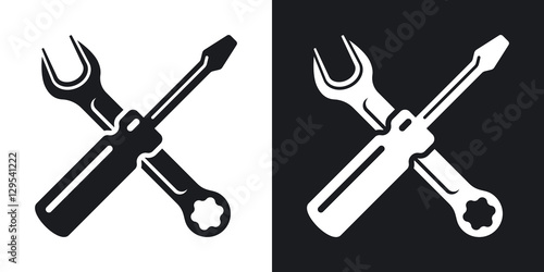 Fototapeta Simple two-color vector icon of a screwdriver and a wrench on a black and white background