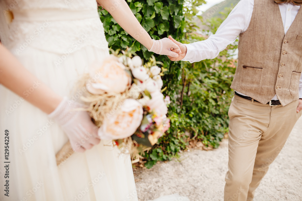 newlyweds holding wedding bouquet newlyweds holding wedding bouquet