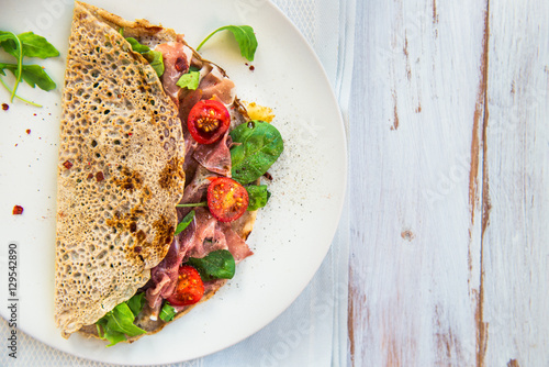Fotografi Buckwheat Pancakes with Cherry Tomatoes, Rocket Salad, Spinach,