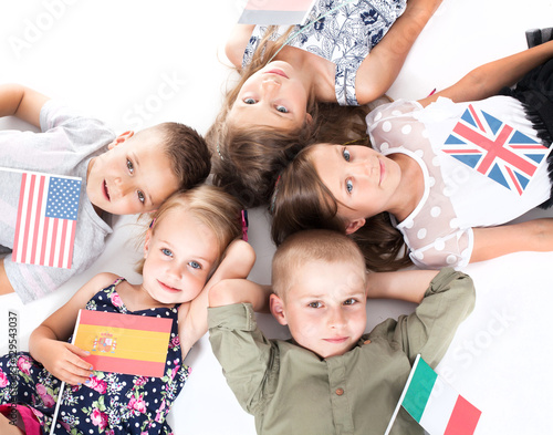 poland group holding flags of different countries. German flag  flag england  spain flag  flag of america  flag of russia  france flag  flag canada 
