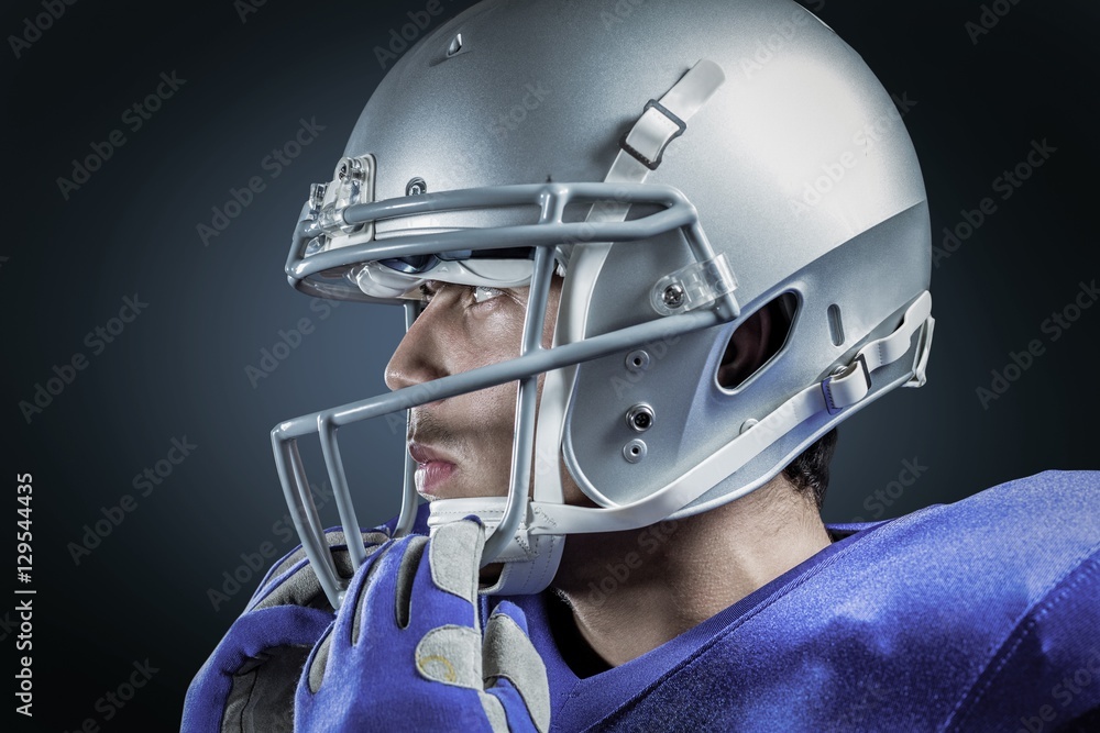Fototapeta premium Composite image of sportsman wearing helmet looking away