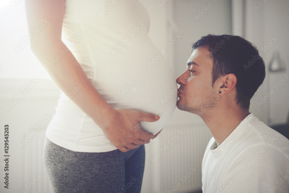 Husband kissing wife belly Husband kissing wife belly