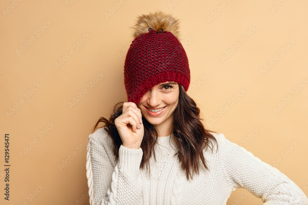 young woman wearing knitted pullover over beige background young woman wearing knitted pullover over beige background