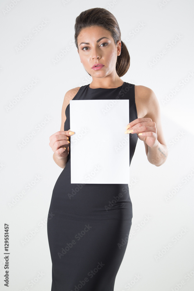 Beautiful Woman In Black Elegant Dress With Classic Hairstyle And Makeup Holding Blank Signboard Over White Background Beautiful Woman In Black Elegant Dress With Classic Hairstyle And Makeup Holding Blank Signboard Over White Background