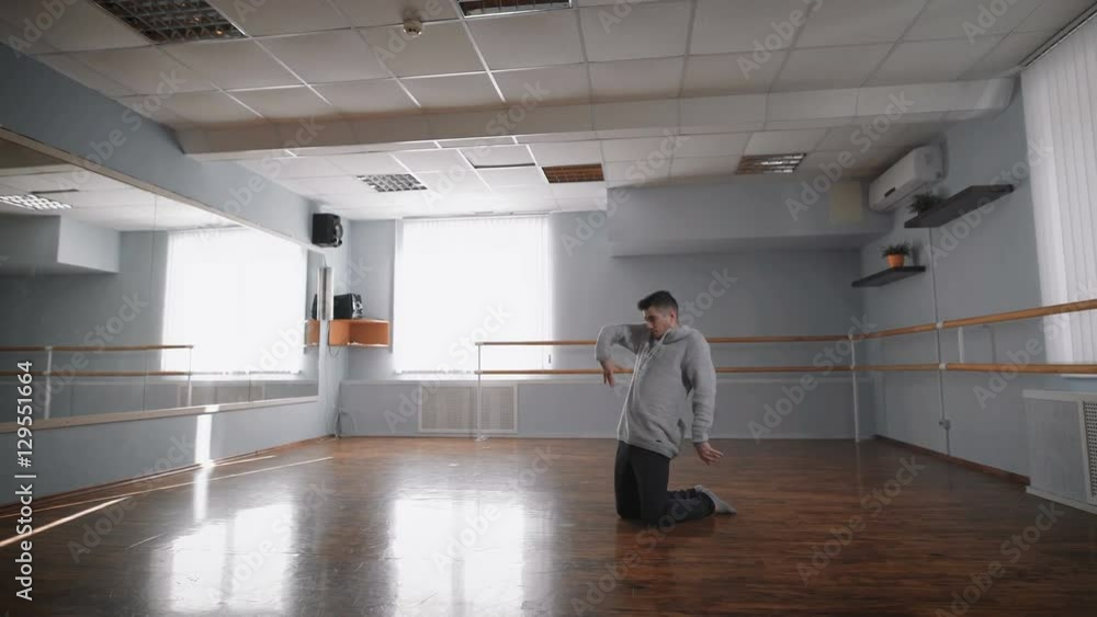 The professional dancer rehearses. He is in the hall for rehearsals. Rehearses the dance contemporary. contemporary. it is constantly improved and unites in itself various dancing techniques. The professional dancer rehearses. He is in the hall for rehearsals. Rehearses the dance contemporary. contemporary. it is constantly improved and unites in itself various dancing techniques.