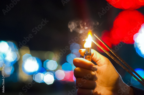Close up of woman holding sparkler on the street. Closeup of Girl
