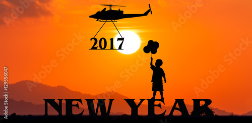 New year 2017 concept ,helicopter take to text 2017 sunset background