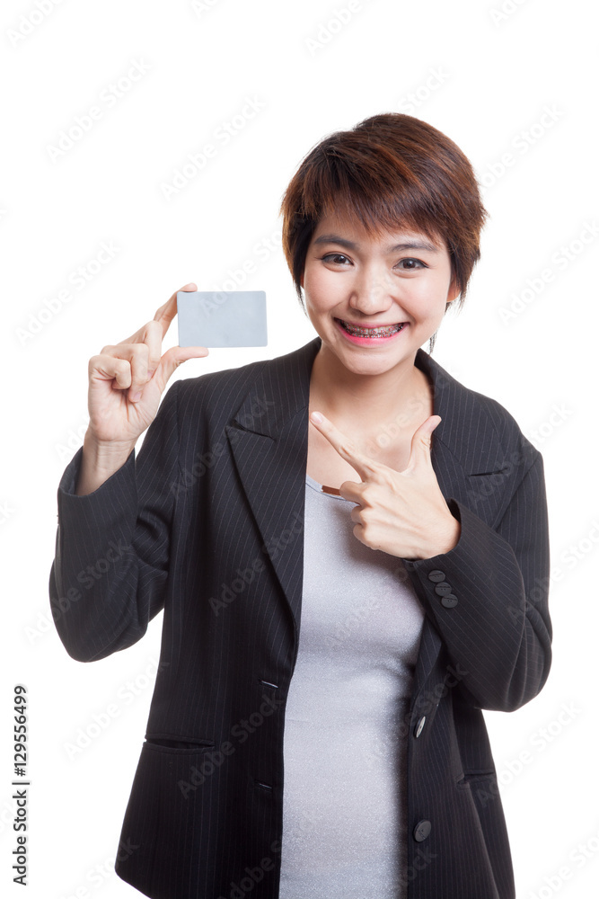 Young Asian business woman point to a blank card. Young Asian business woman point to a blank card.