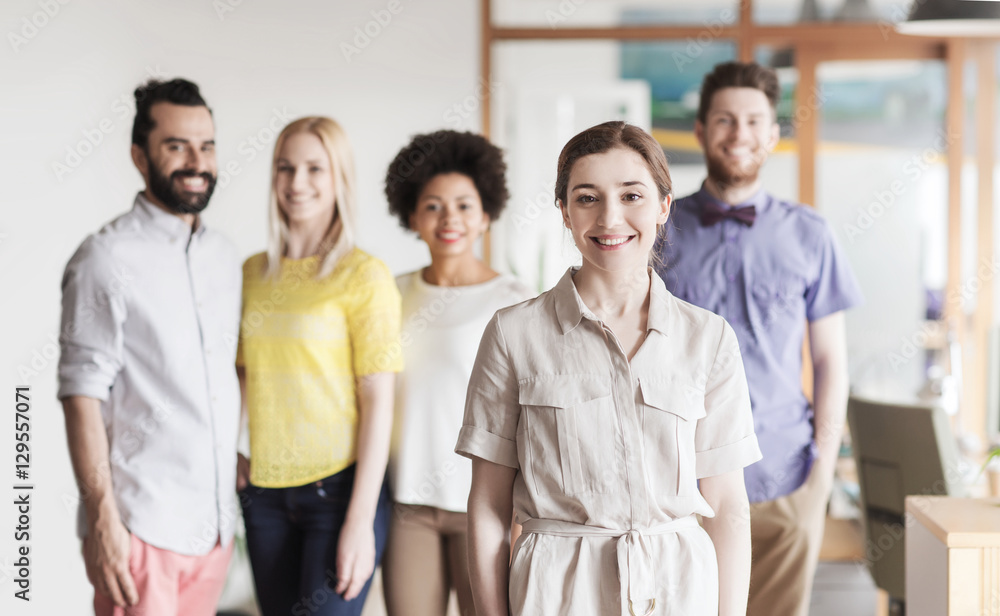 happy young woman over creative team in office happy young woman over creative team in office