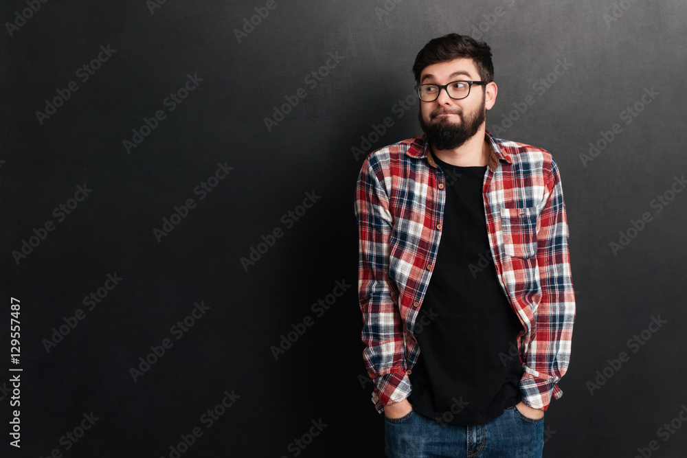 Cheerful man standing over chalkboard