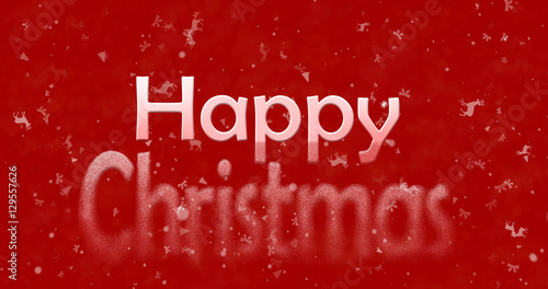 Happy Christmas text turns to dust from bottom on red background