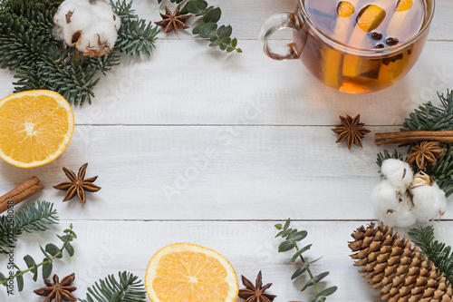 Christmas, New Year winter holiday white wooden background and frame with a cup of tea and oranges photo