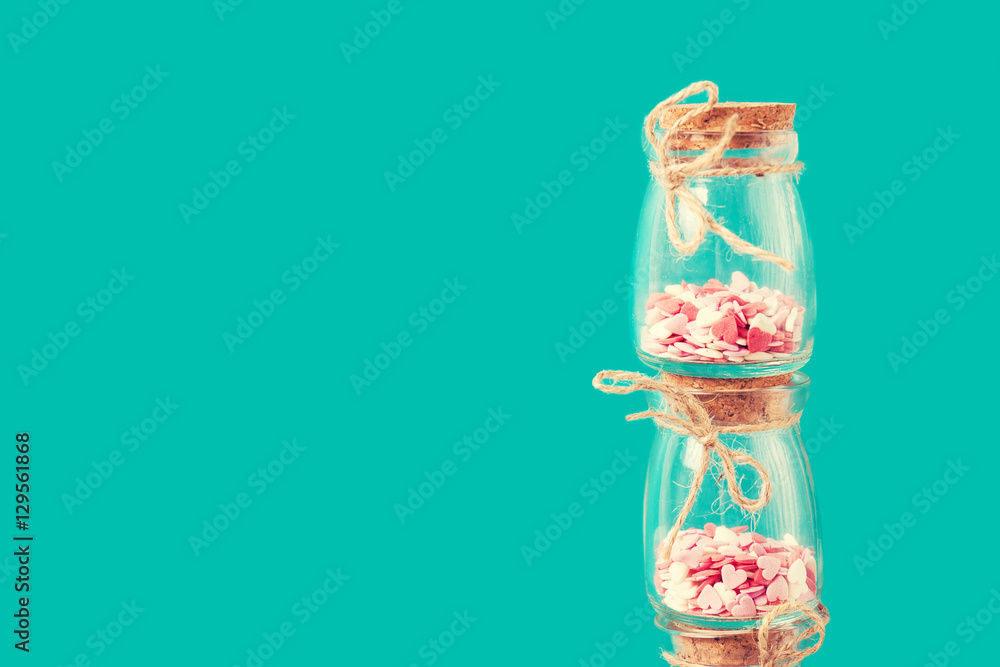 Love concept with jars on a turquoise background, horizontal, pa