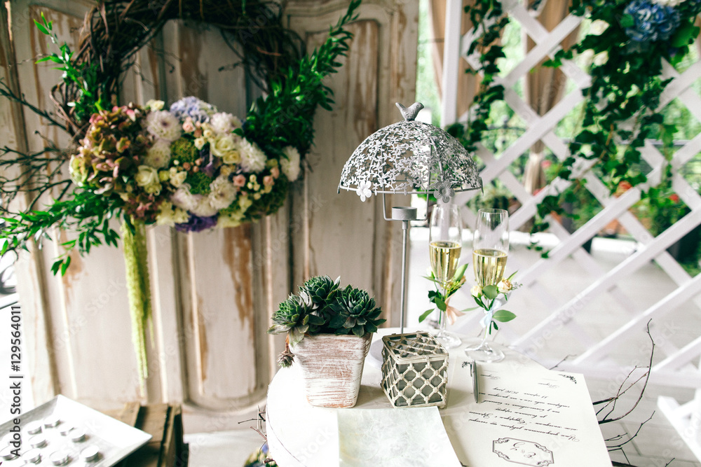Little table with wedding documents and decor stands on porch