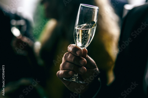 Man holds glass with champagne