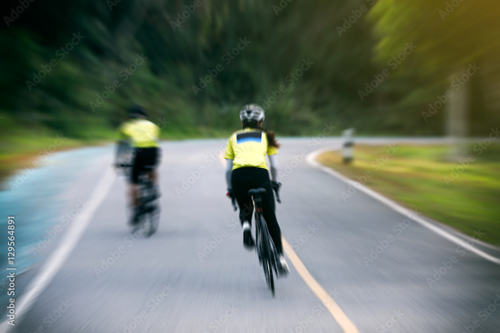 Motion blurry of Asian women Cycling during the race on road